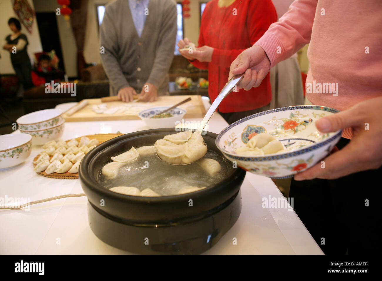 Chinese family making Chinese dumpling on New Year's Eve Stock Photo ...