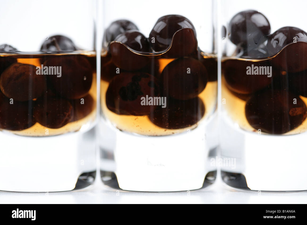 Sloe berries in small glasses with sloe gin Stock Photo