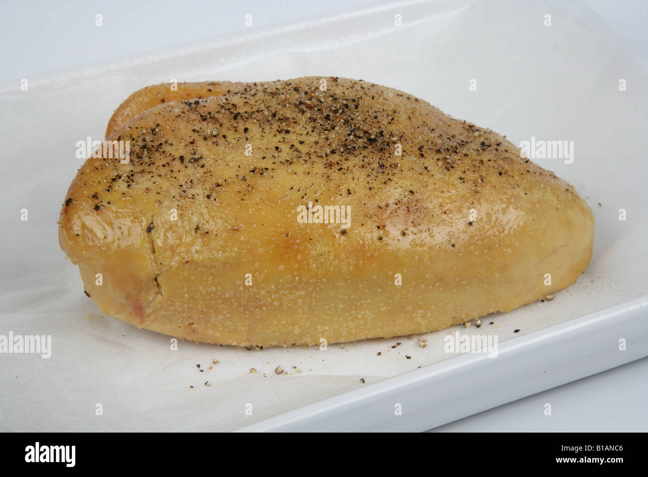 Liver marinating on a tray with ground pepper hires stock photography