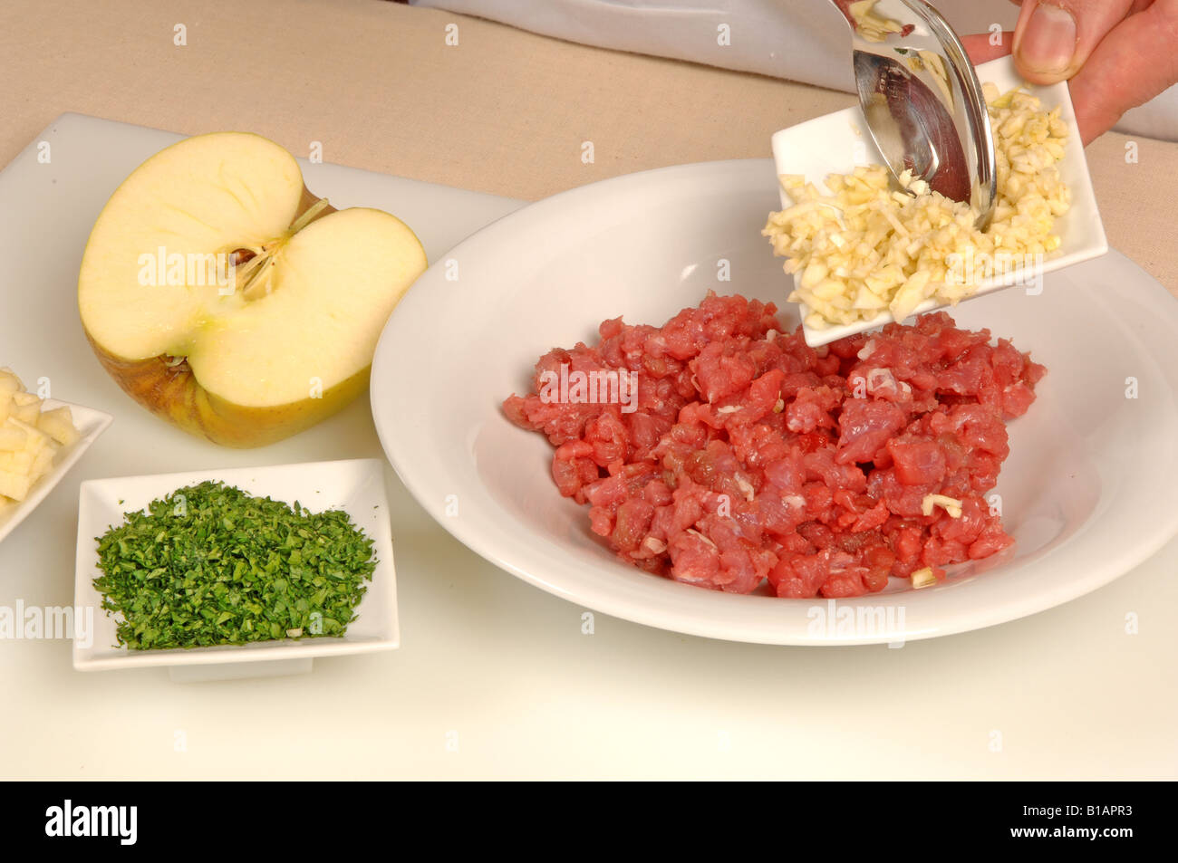 Folding ingredients into minced beef to make burger Stock Photo Alamy