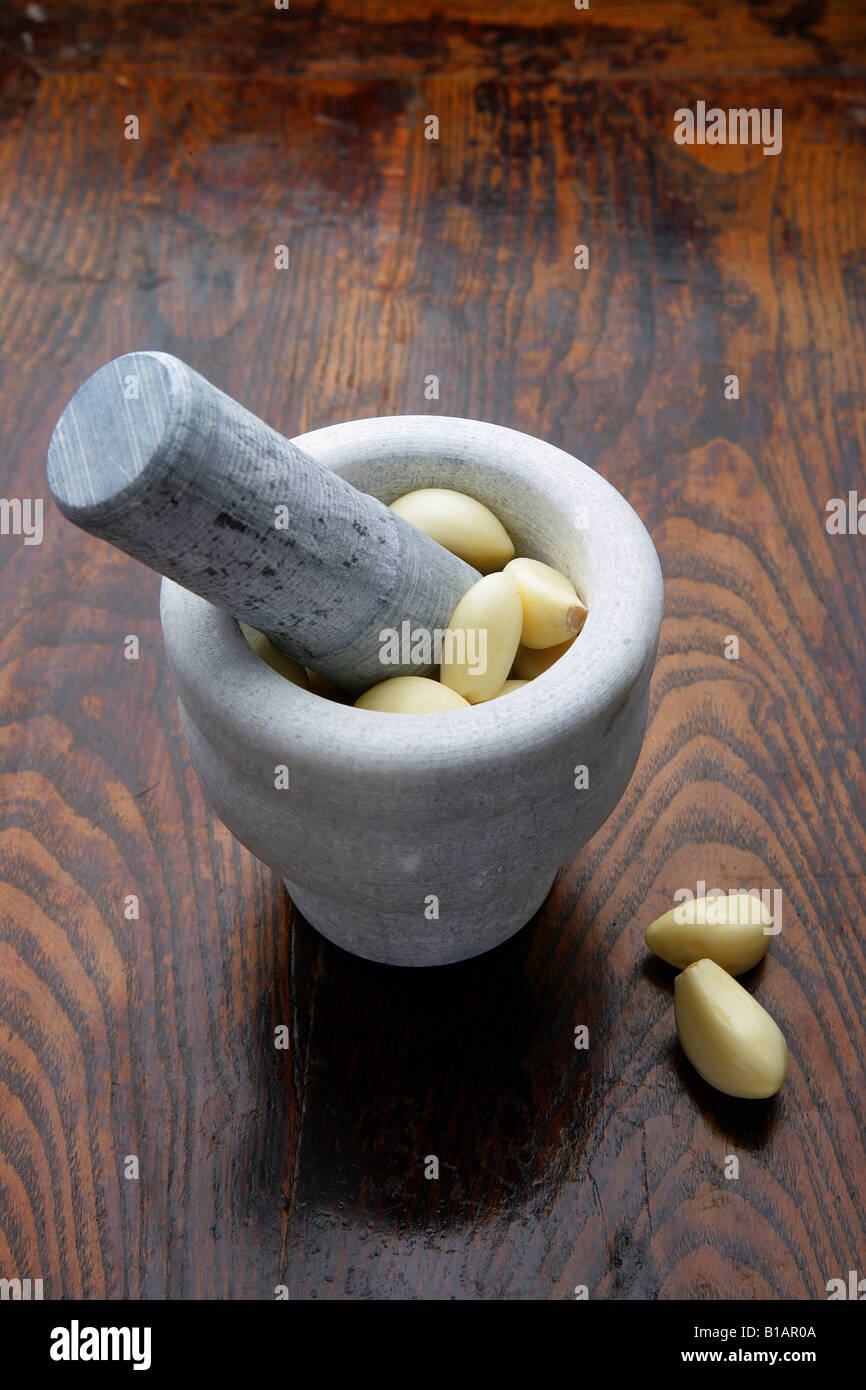 Mortar and pestle with cloves of garlic, high angle view Stock Photo Alamy