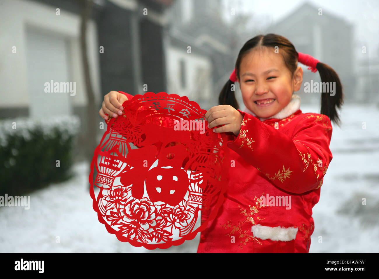 one chinese girl holding a paper cut smiling Stock Photo