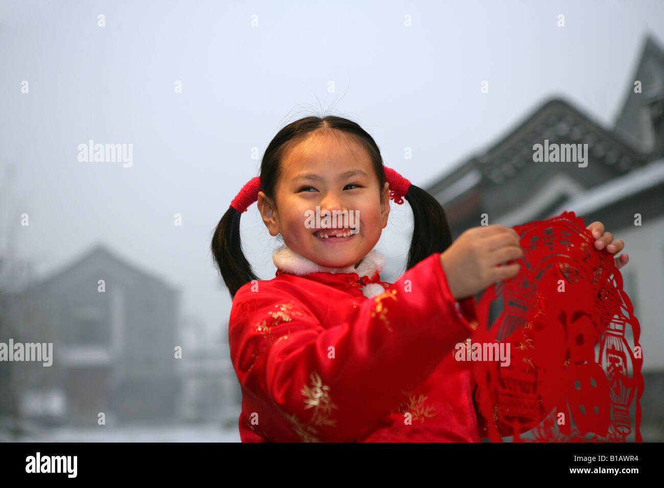 one chinese girl holding a paper cut smiling Stock Photo
