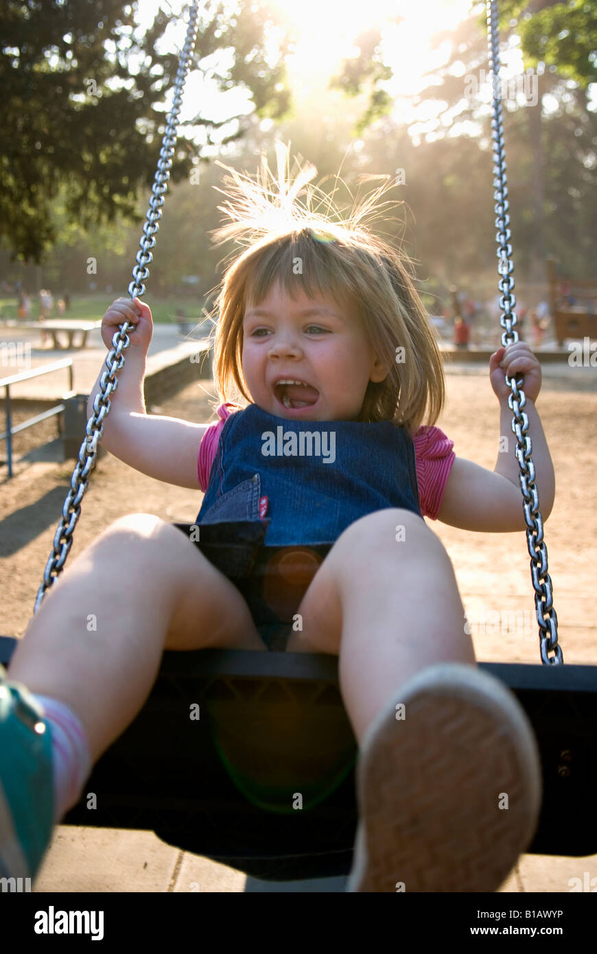 Girl (3-4) on swing, portrait Stock Photo