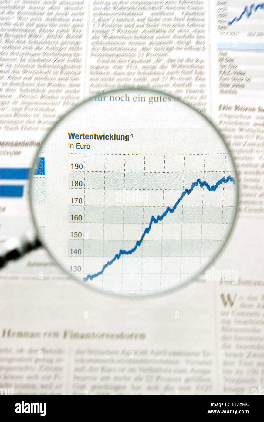 View of graph in newspaper trough magnifying glass, close up Stock Photo