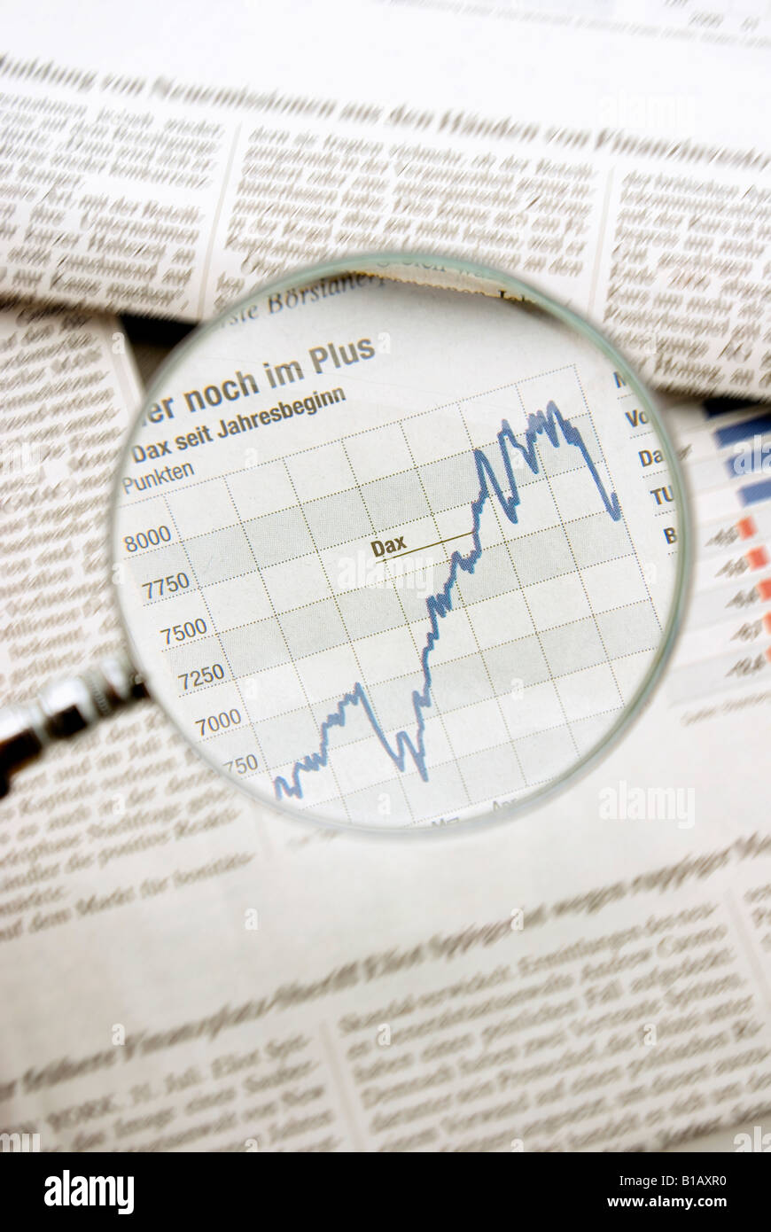 View of graph in newspaper trough magnifying glass, close up Stock Photo