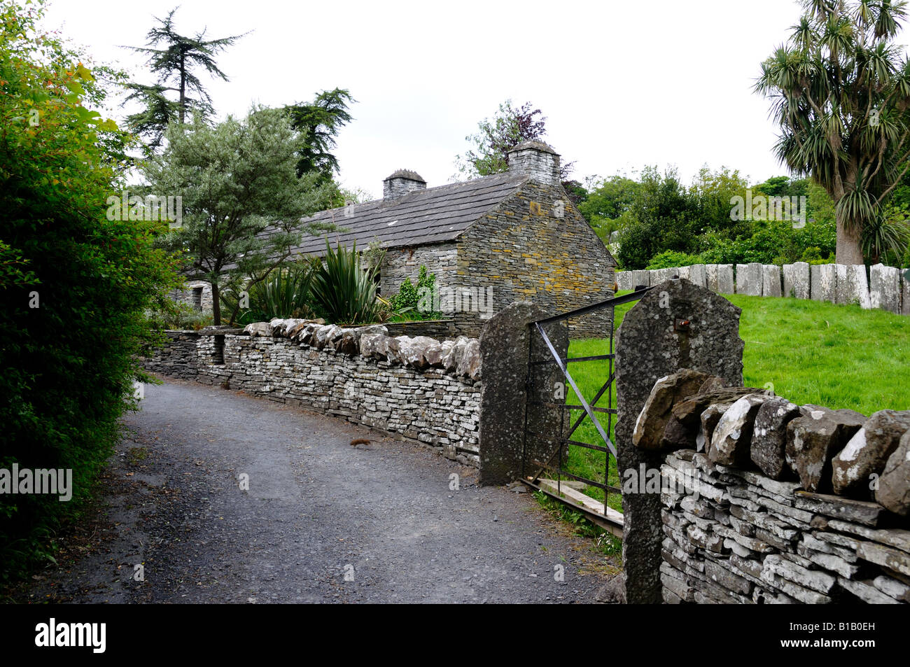 Old stone farm house fenced in by stone walls in Bunratty Castle and