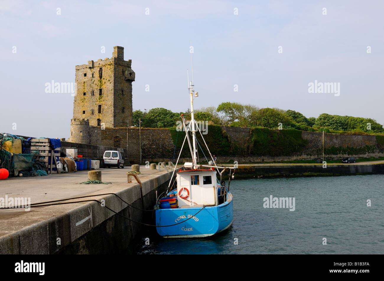 A boat and a castle on the coast of western Ireland. Stock Photo