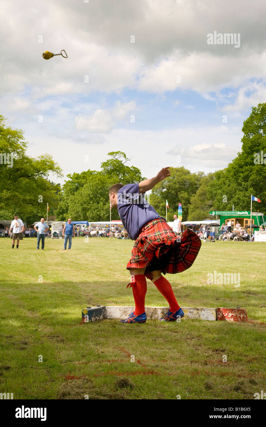 Scottish event, throwing a round metal ball chain stone shot, strongman event at the Strathmore Highland Games Scotland UK Stock Photo
