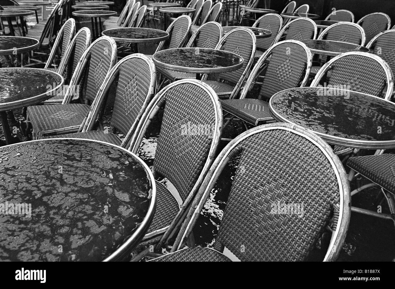 France, Paris, Bistro tables and chairs in the rain Stock Photo