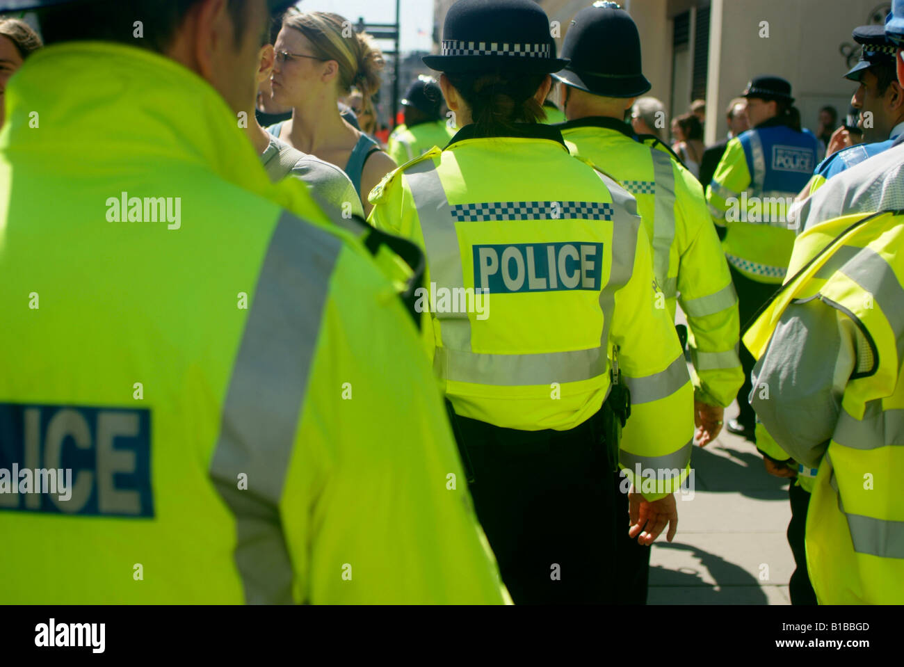 police officer officers london uk hi vis vest yellow Stock Photo