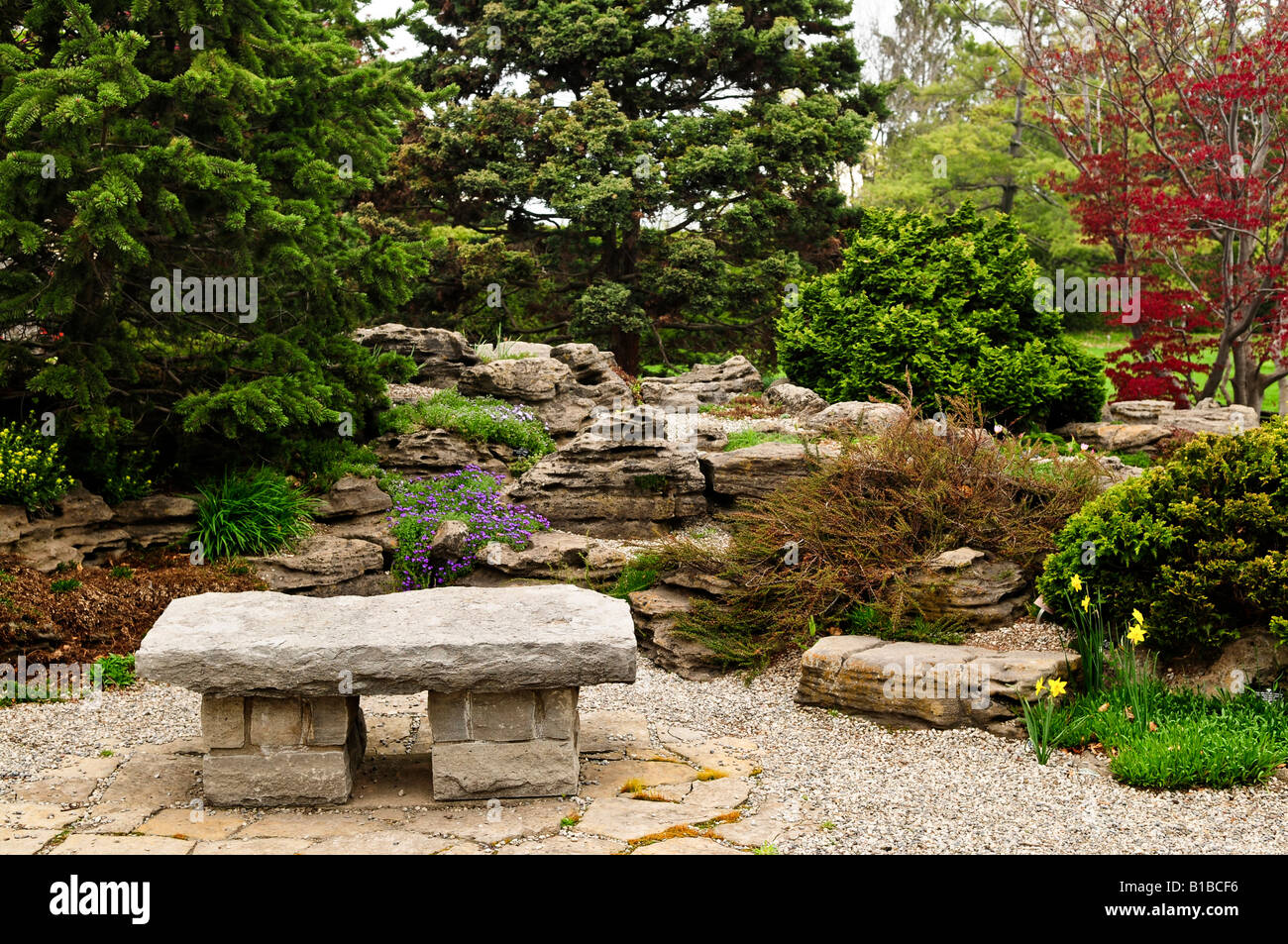 Japanese zen garden with natural stone bench Stock Photo