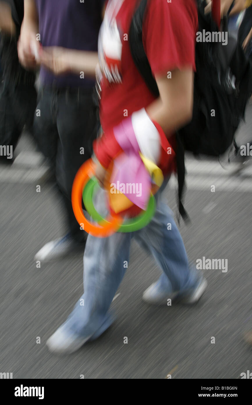 man carrying colourful juggling rings in town Stock Photo - Alamy