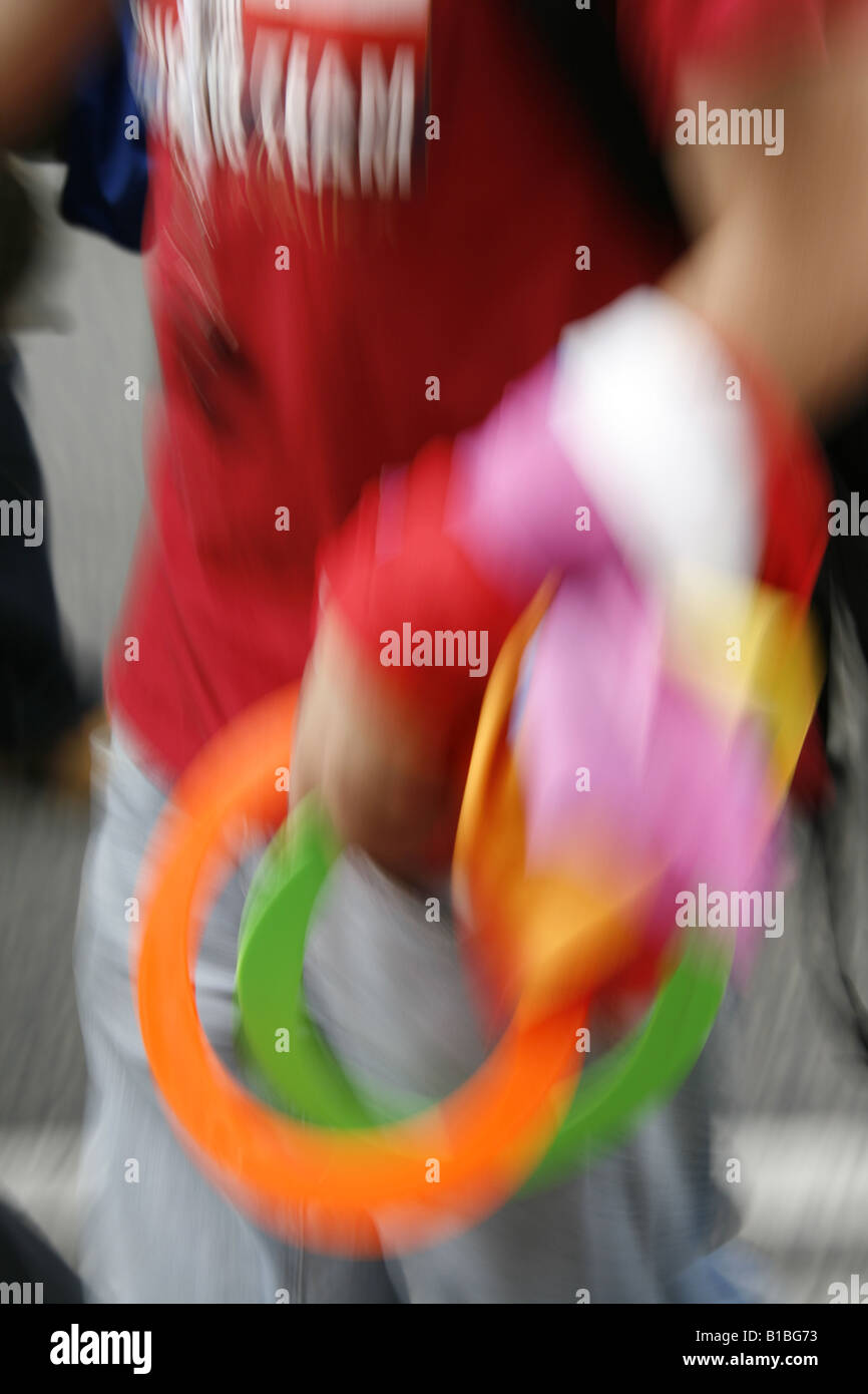 Human Juggling Rings man carrying colourful juggling rings in town Stock Photo - Alamy