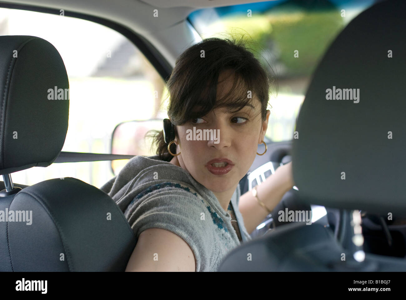 Young Hispanic Woman Attempts To Drive And Back Up Her New SUV sports