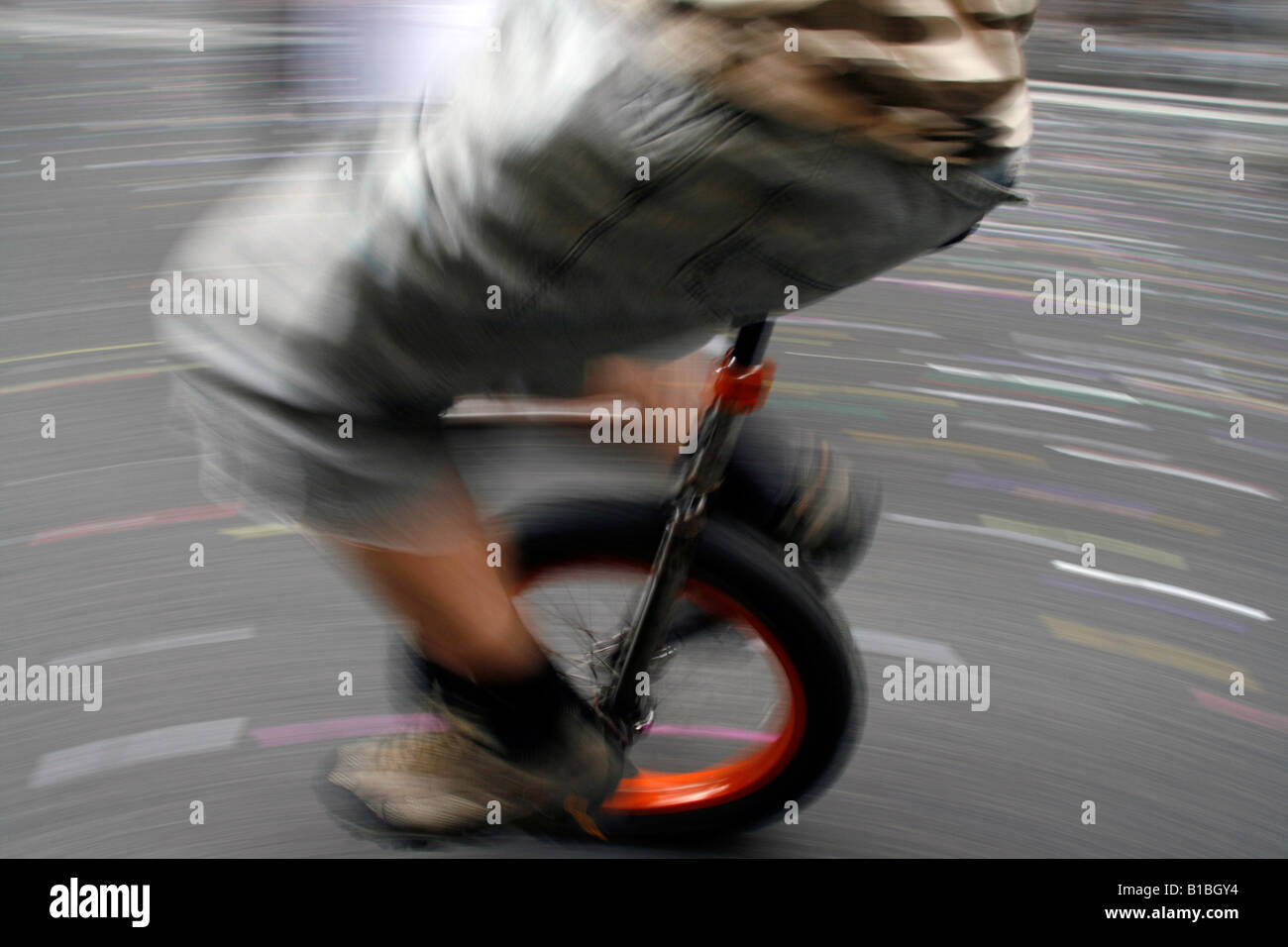 fast unicycle rider in town Stock Photo Alamy