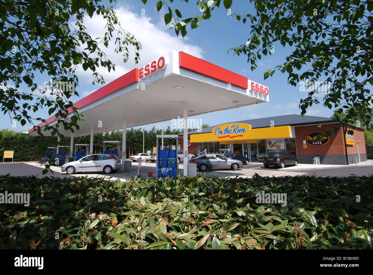 Esso petrol station forecourt with "On the Run" convenience store near