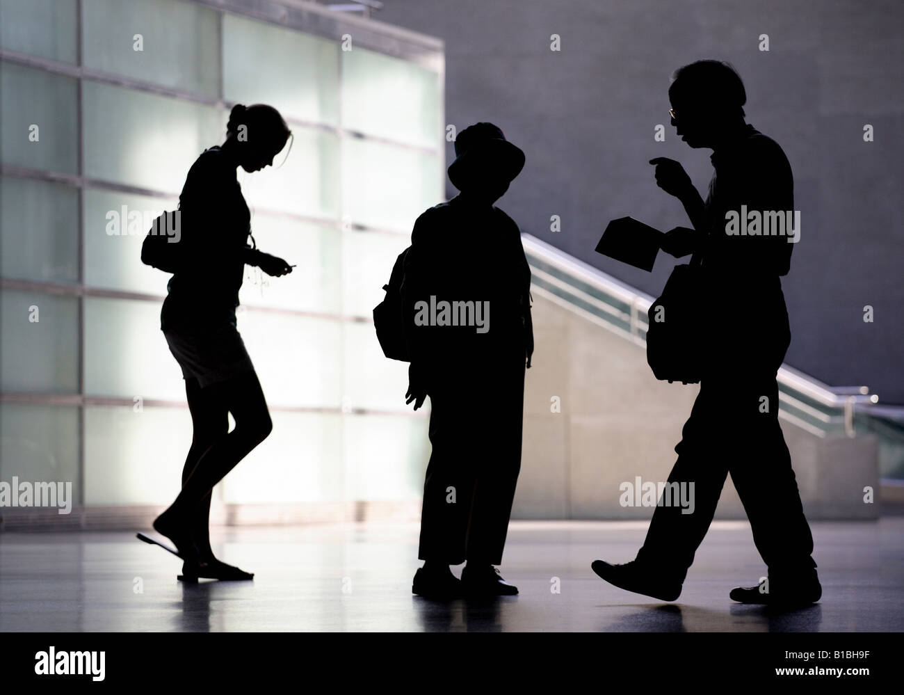 Silhouettes of people walking Stock Photo