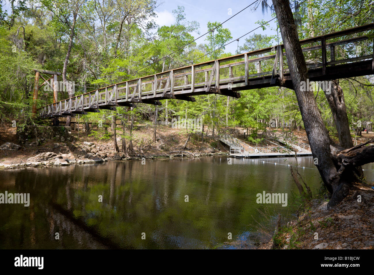 Wooden pedestrian suspension bridge over Santa Fe River on trail in O