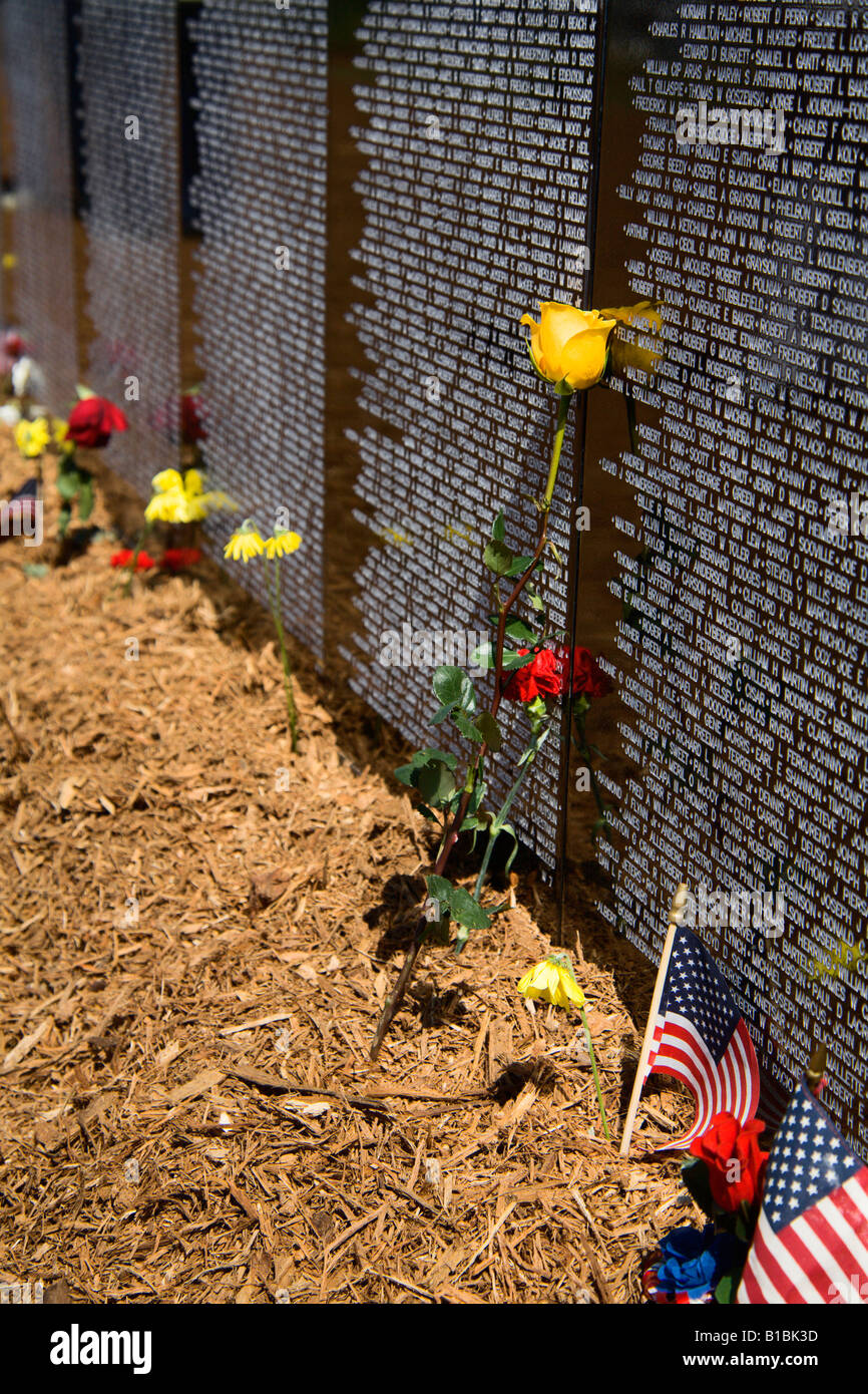 Flowers left at the base of the Vietnam traveling memorial wall Stock ...