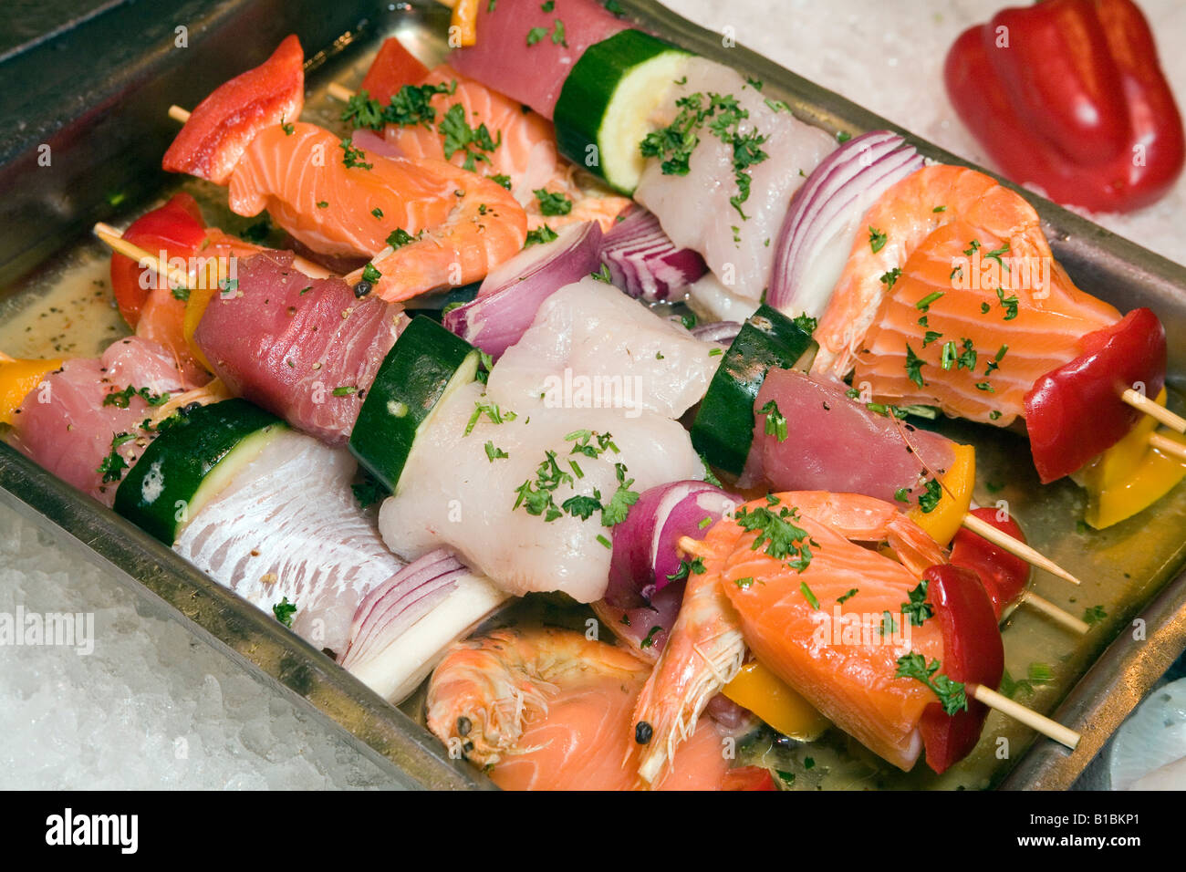 Seafood barbecue Skewers with mixed fish salmon cod tuna onion cucumber