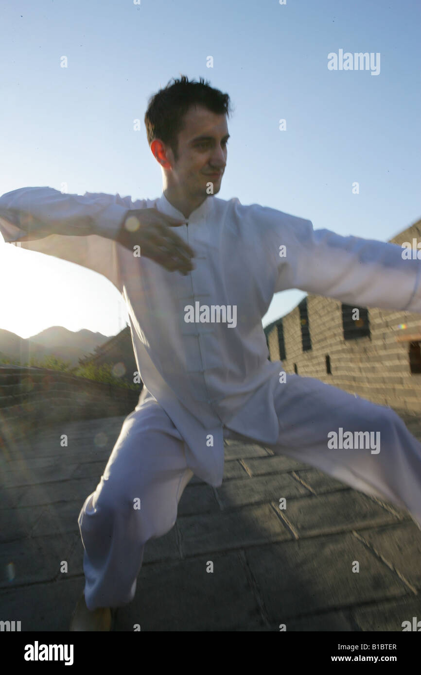 caucasian in Chinese traditional clothing practising martial arts on