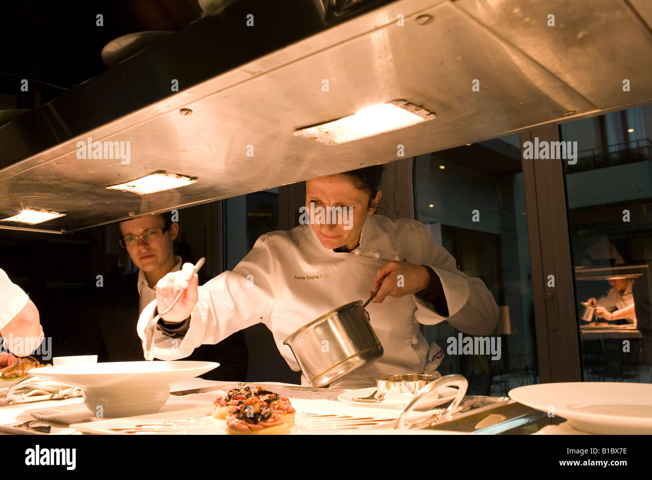 Anne Sophie Pic working in the kitchen of her restaurant Maison Pic. Stock Photo