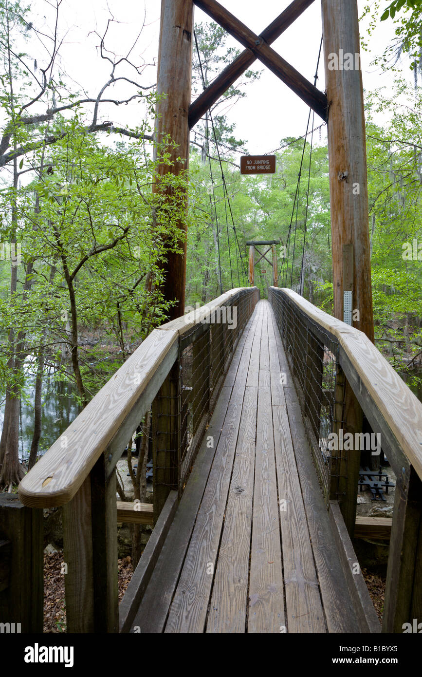 Wooden pedestrian suspension bridge over Santa Fe River on trail in O