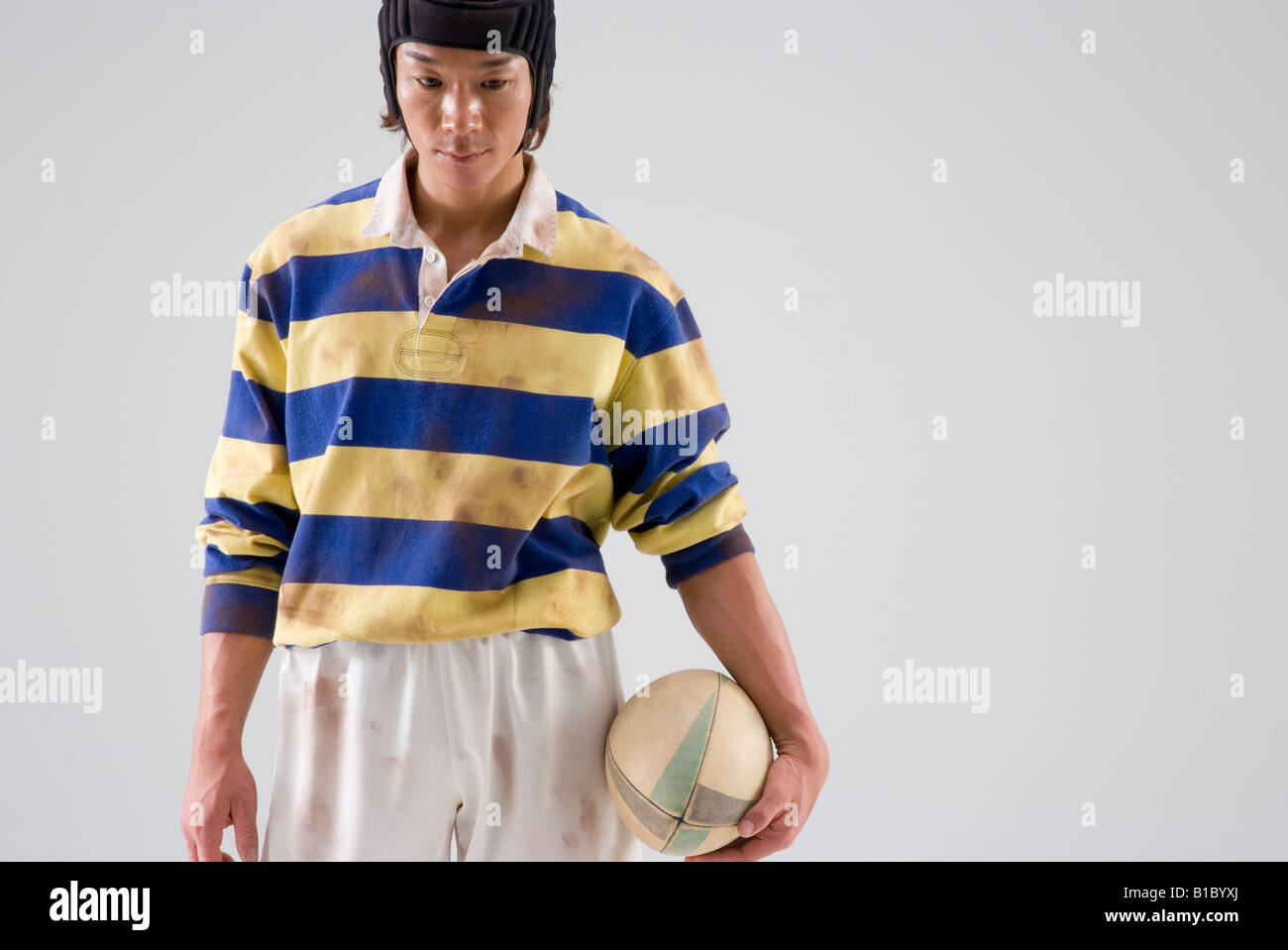 Rugby player holding ball Stock Photo Alamy