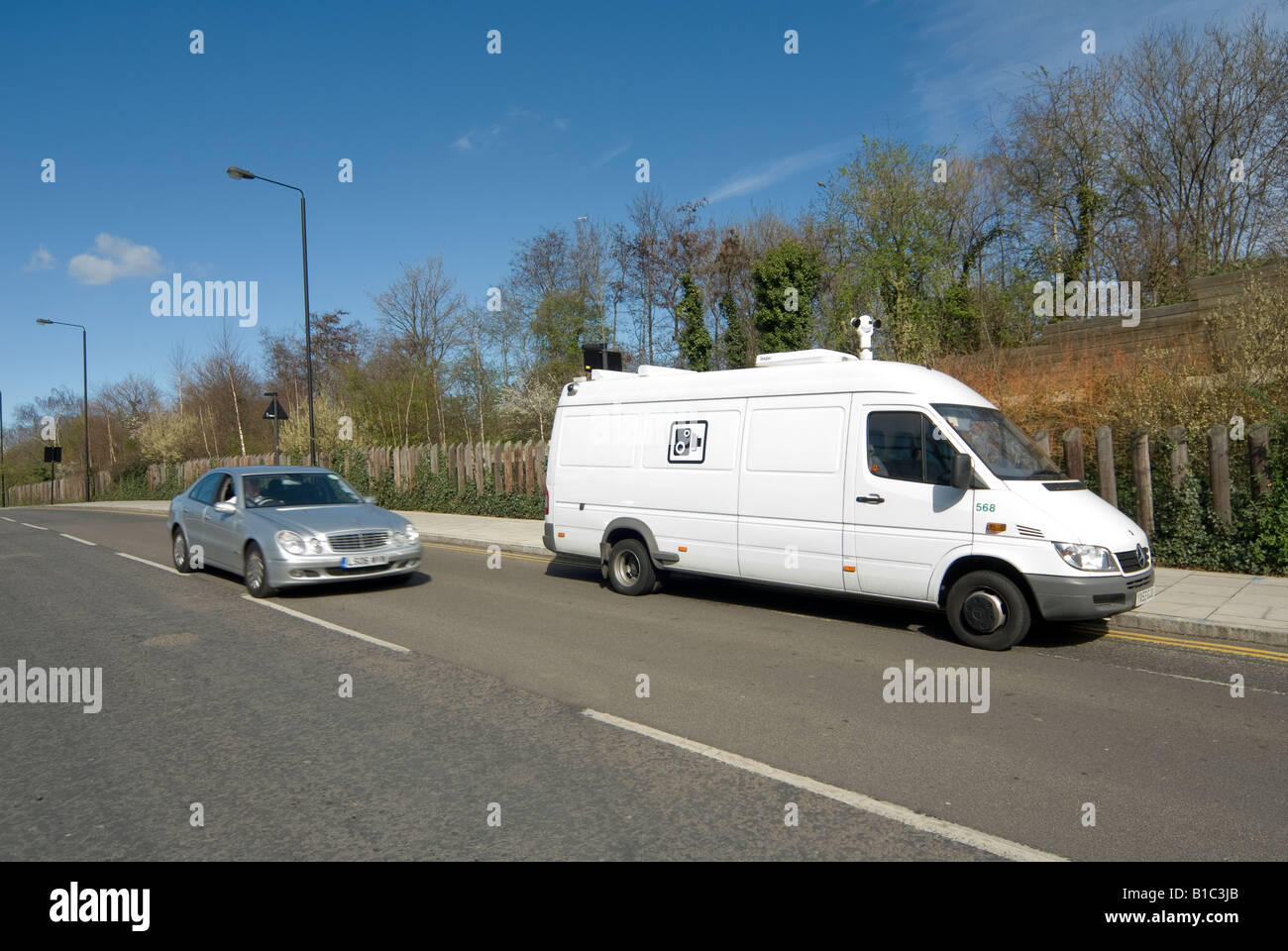 Silver mercedes car speeding past a white speed camera van in the centre of  the city of London England Stock Photo - Alamy
