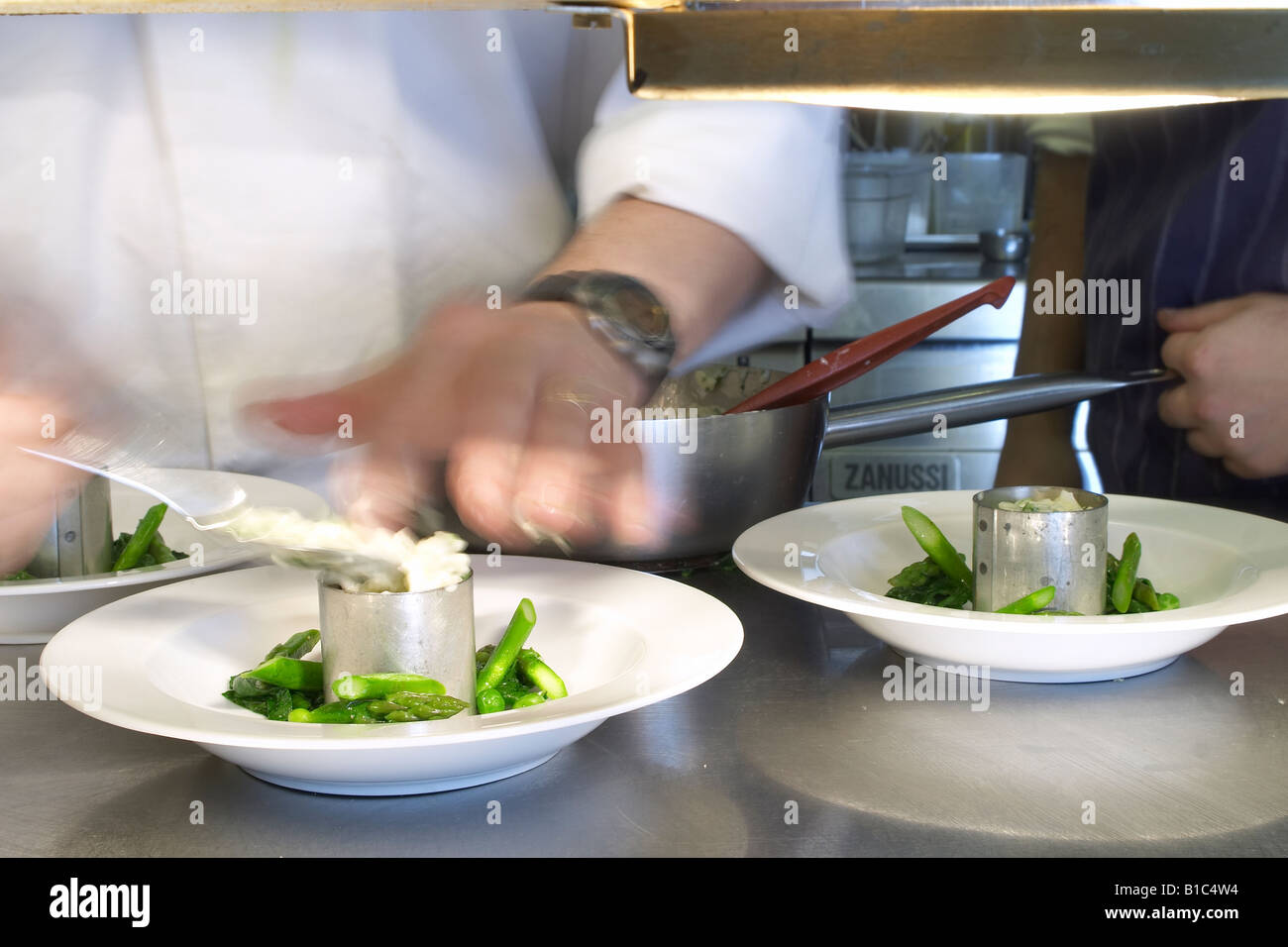 Chefs plating food at service Stock Photo