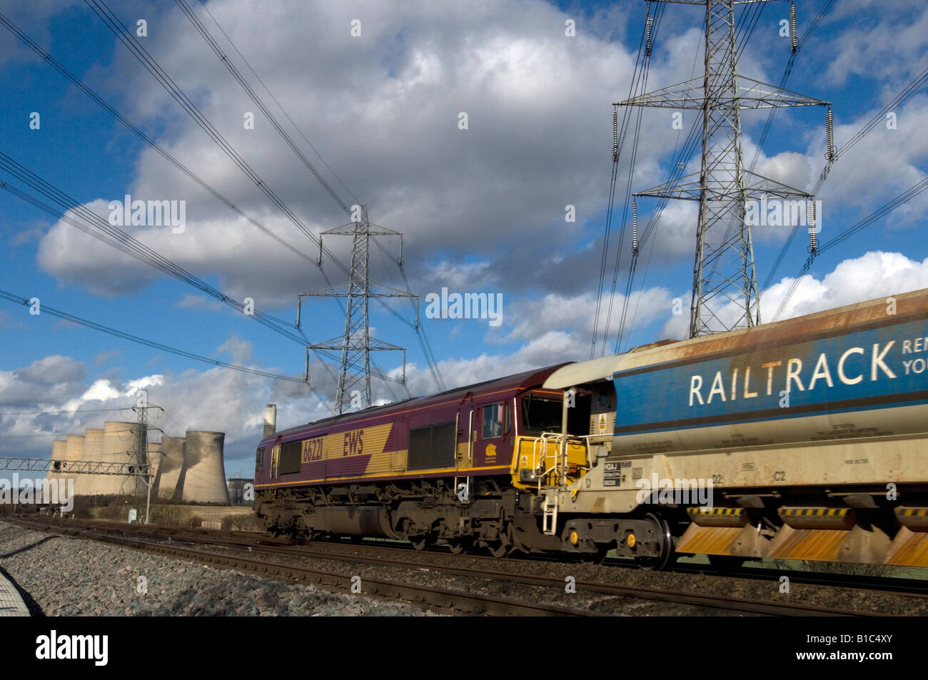 An EWS freight engine hauling a Railtrack track relaying train past the ...