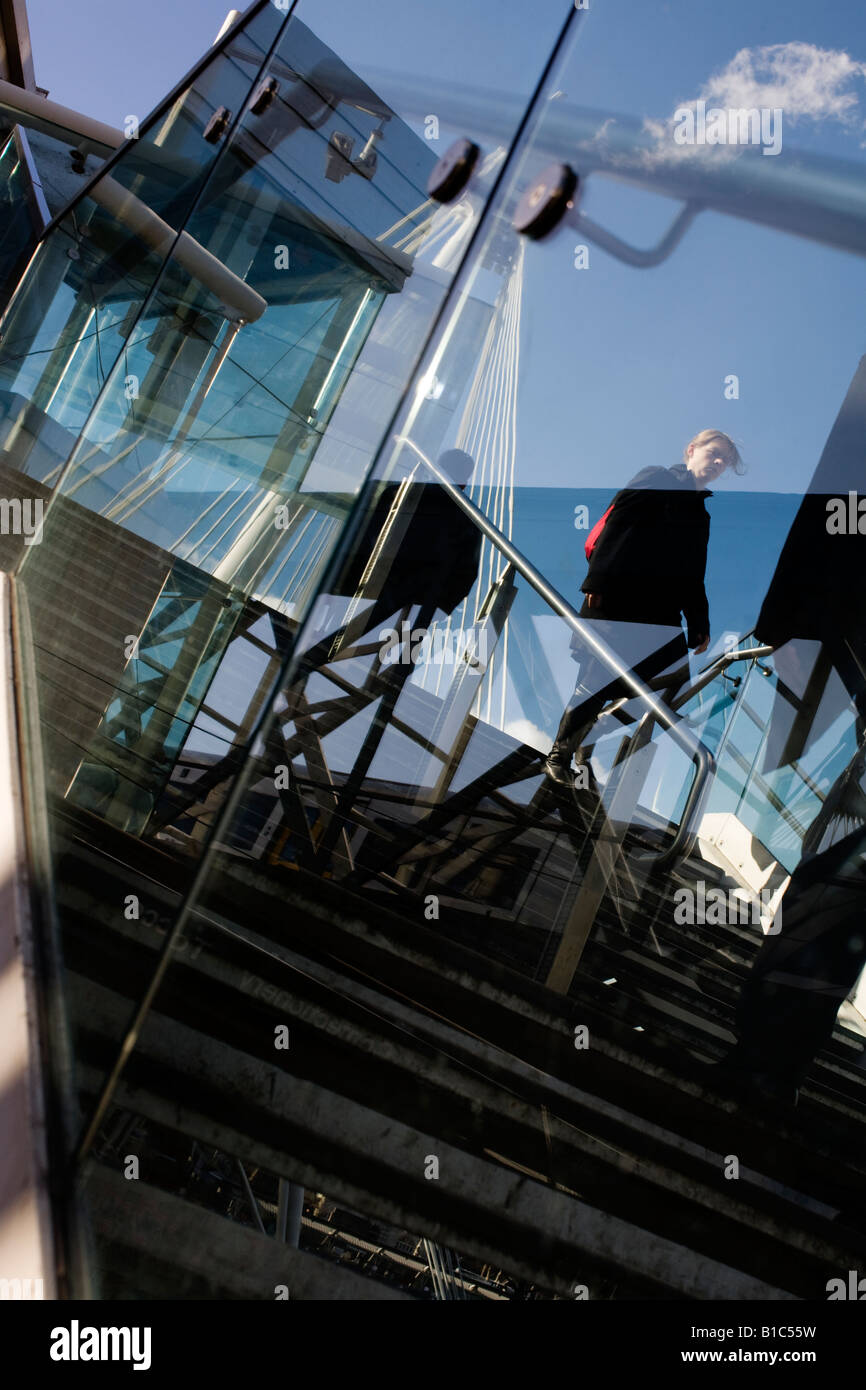 Pedestrian crosses the River Thames by the Hungerford Bridge, London