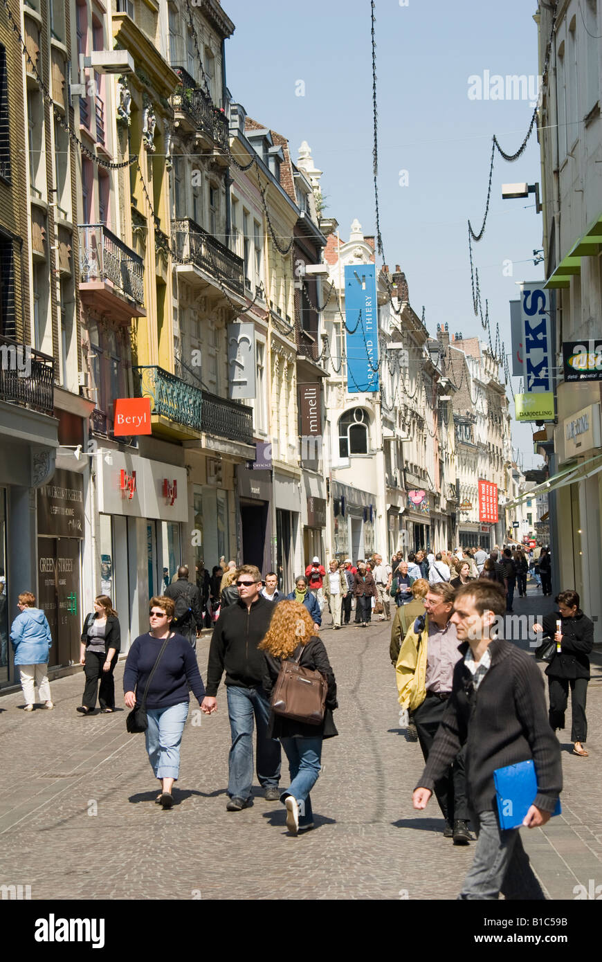 Pedestrians and shops on a busy street in the french town of Lille ...