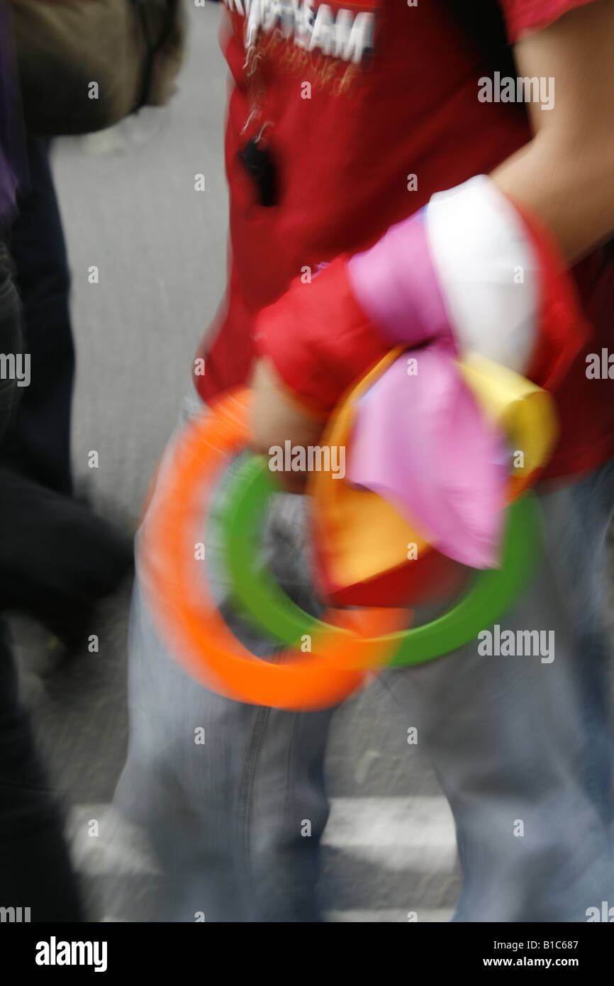 man carrying colourful juggling rings in town Stock Photo - Alamy