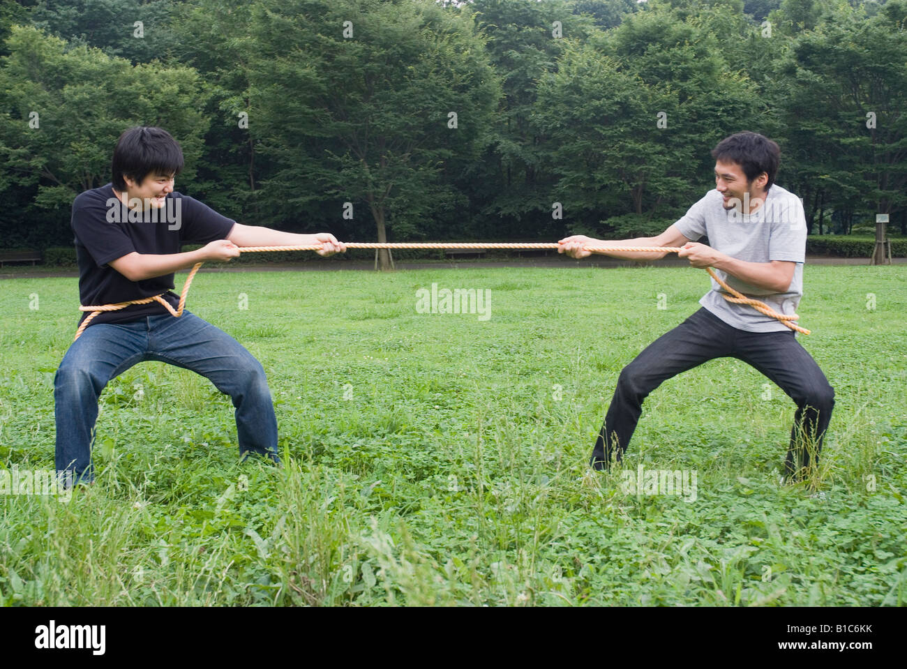 Two young men pulling rope Stock Photo Alamy
