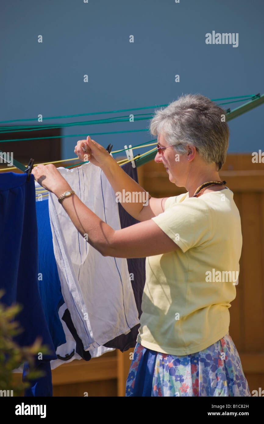 Lady hanging out the washing to dry Stock Photo