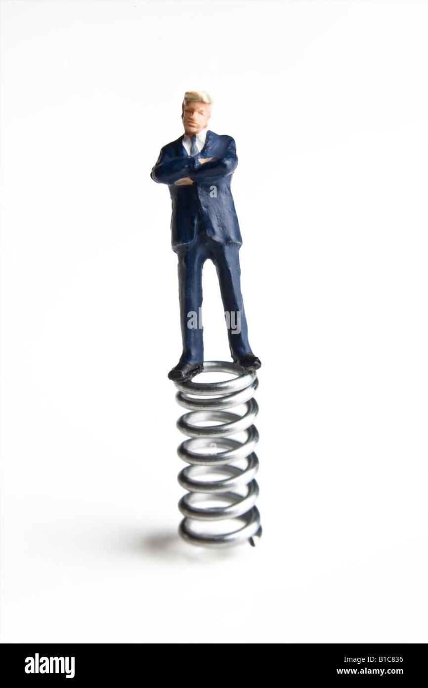 Businessman figurine standing on a spring Stock Photo