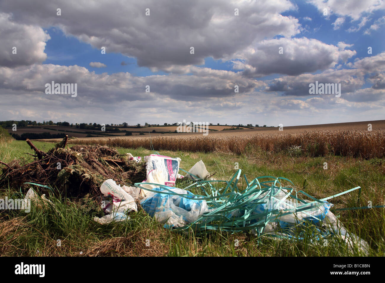 Fly tipping in a farmers field in Suffolk East Anglia Stock Photo