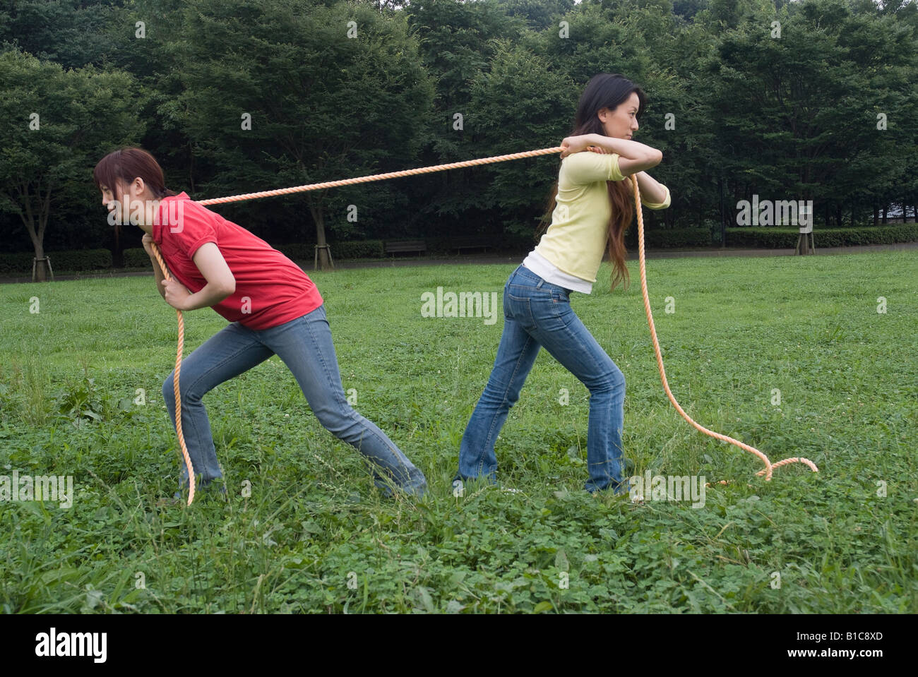 Two young women pulling rope Stock Photo Alamy
