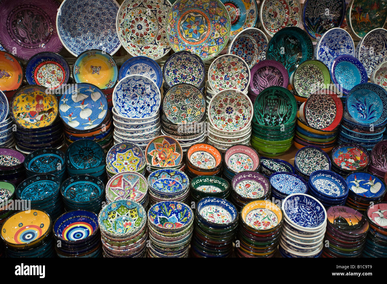Painted Bowls all for sale. A huge display of brightly decorated ceramic bowls and plates on