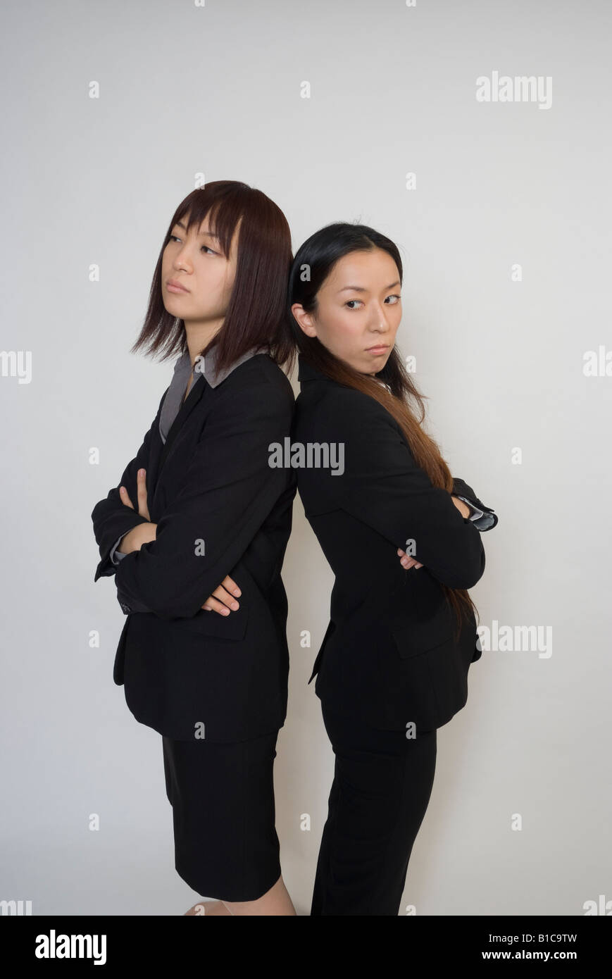 Two young businesswomen confronting Stock Photo