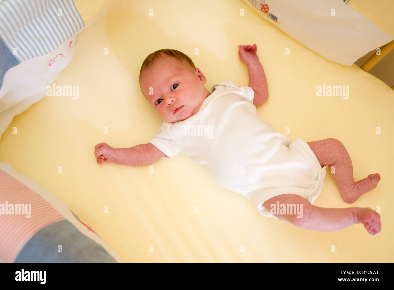 Baby lying in cot Stock Photo Alamy