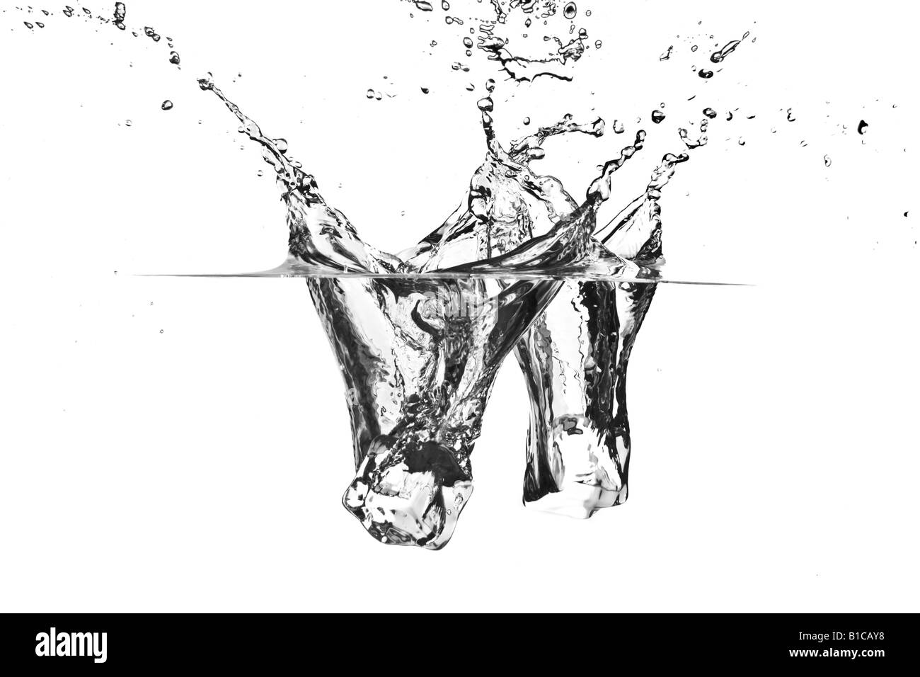 Ice cube dropped into water Stock Photo - Alamy