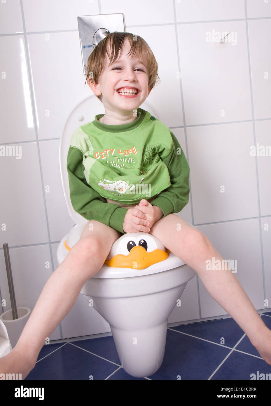 little boy sitting on the toilet Stock Photo