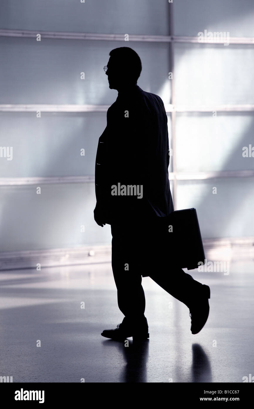 Silhouette of a man in a suit and with a briefcase Stock Photo - Alamy