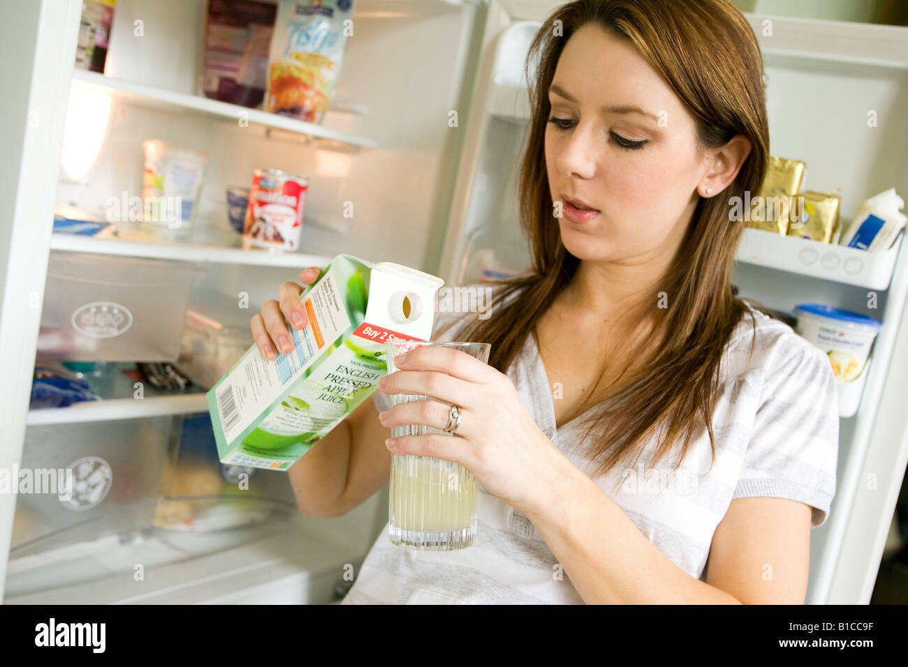 Pregnant woman drinking fruit juice Stock Photo Alamy