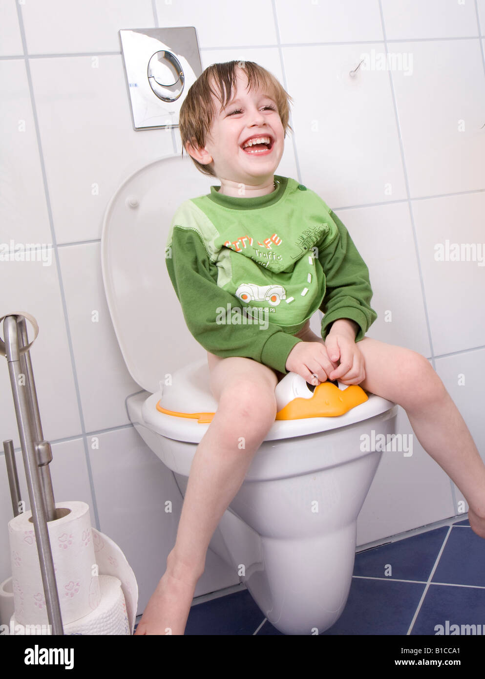 little boy sitting on the toilet Stock Photo