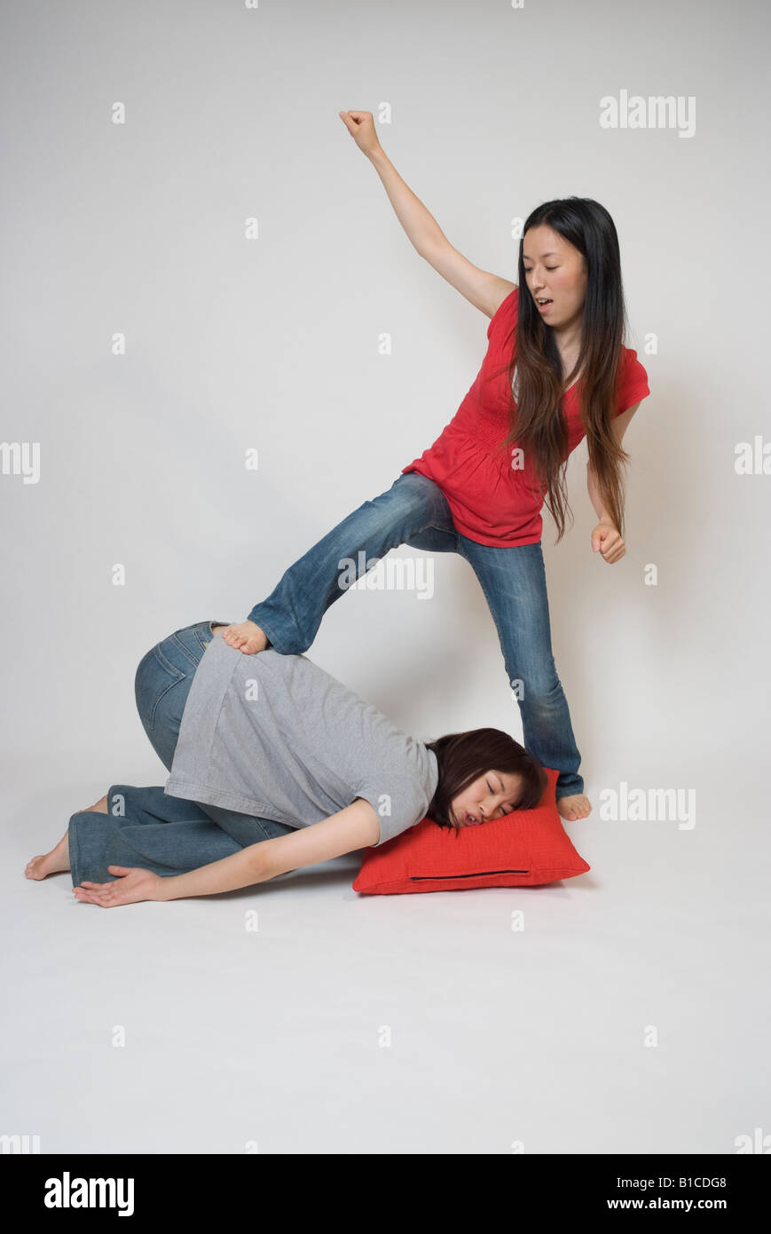 Young woman bullying another woman Stock Photo