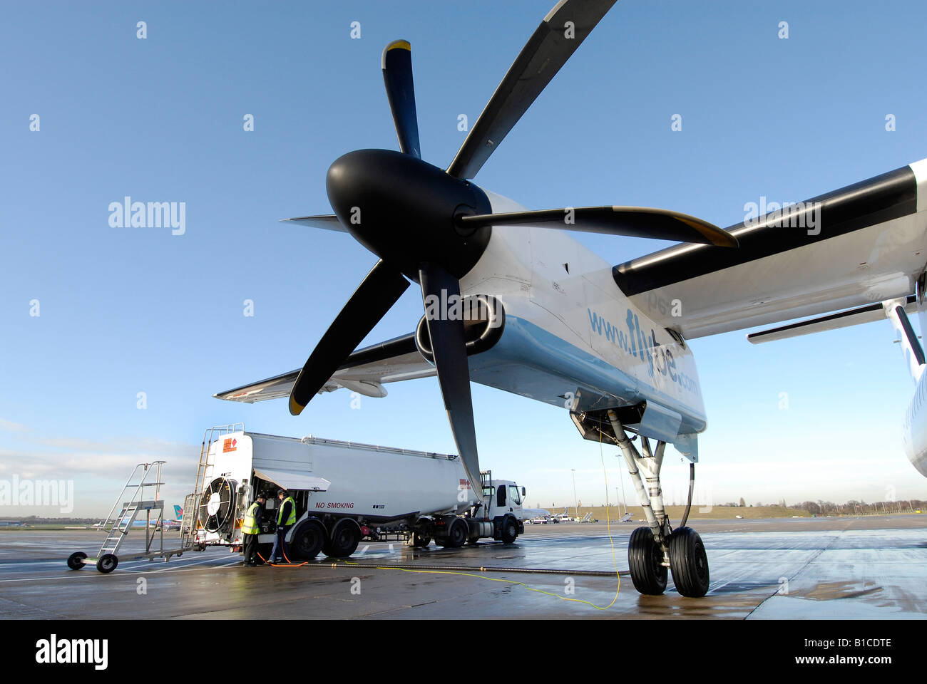 Aircraft refuelling with tanker at airport Stock Photo
